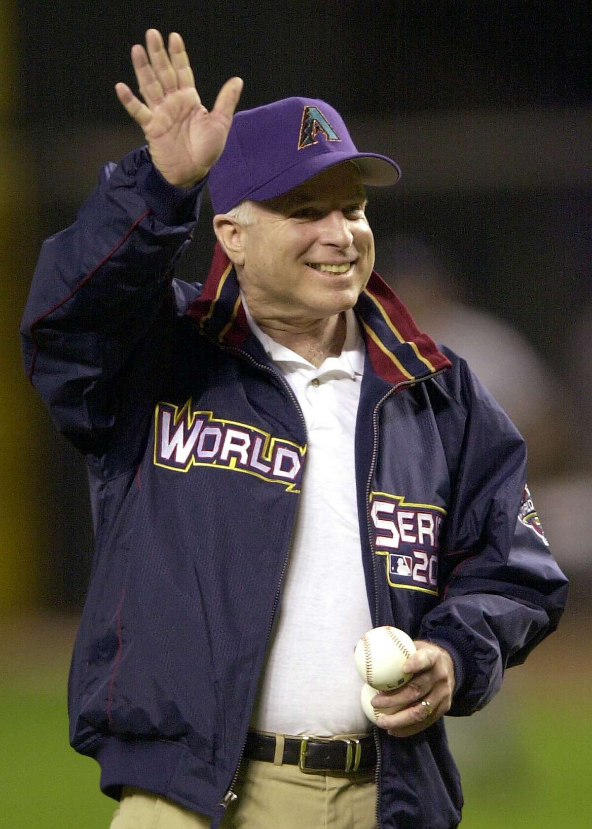 FILE - In this Nov. 4, 2001, file photo, Republican presidential candidate Sen. John McCain, R-Ariz., waves to the crowd prior to Game 7 of the World Series between the Arizona Diamondbacks and the New York Yankees at Bank One Ballpark in Phoenix. The sight of McCain sitting in the stands at Chase Field, formerly Bank One Ballpark, became so commonplace few people seemed to even notice. The senator from Arizona would get handshakes and take pictures with fans, but he was there just to be one of them, cheering on the home team. McCain died Saturday, Aug. 25, 2018, after battling brain cancer and the Arizona sports community mourned him across the Valley of the Sun. He was 81. (AP Photo/John Bazemore, File)