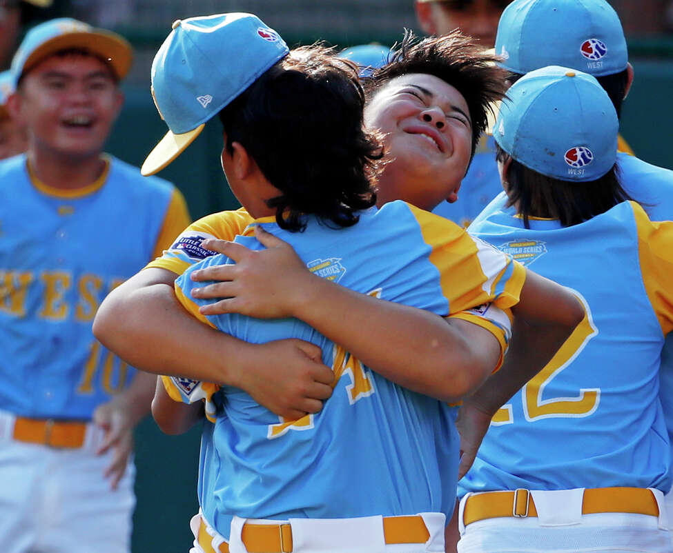 Honolulu, Hawaii's Sean Yamaguchi, right center, hugs Ka'olu Holt as they celebrate getting the final out of the United States Championship baseball game against Peachtree City, Georgia at the Little League World Series tournament in South Williamsport, Pa., Saturday, Aug. 25, 2018. Hawaii won 3-0 and will face South Korea in the Little League World Series Championship game Sunday. (AP Photo/Gene J. Puskar)