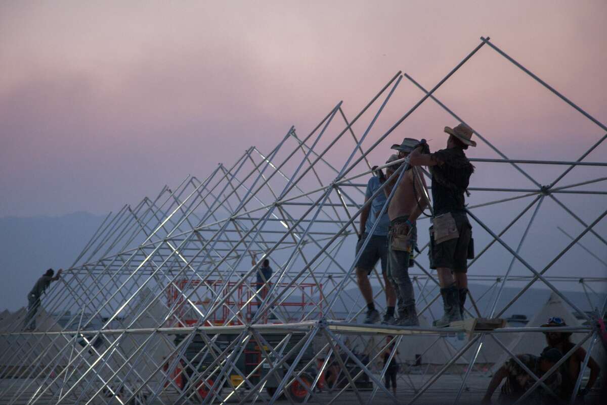 Early arrivals to Burning Man take part in "Build Week" ahead of the main event, showing some of the work, art setup and mutant cars that arrive on the playa before most attendees.