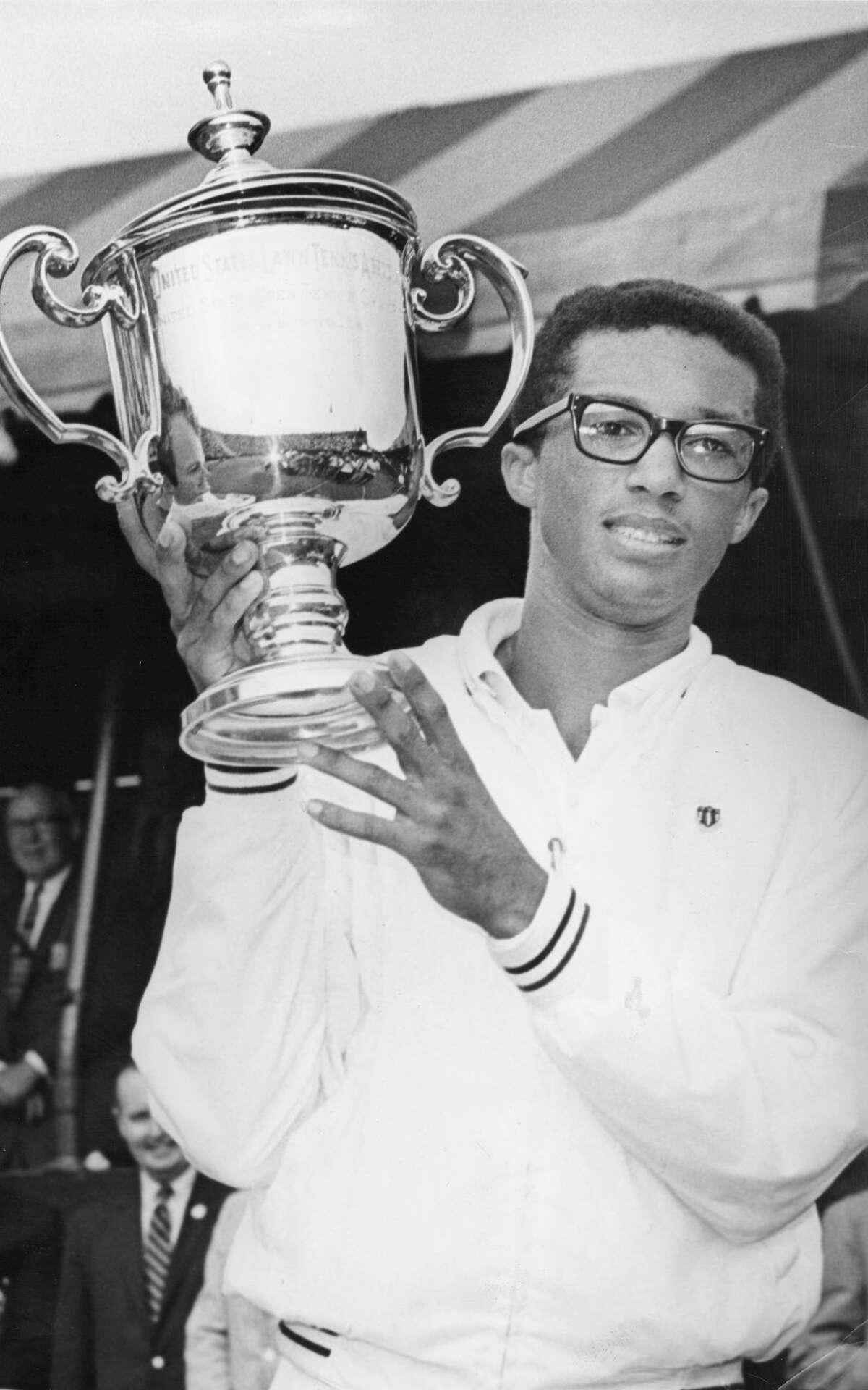 At the U.S. Open, Arthur Ashe proudly holds the winner's trophy, gained by beating Tom Okker on the left, who holds his Silver Tray. September 10, 1968. (Photo by William N. Jacobellis/New York Post Archives /(c) NYP Holdings, Inc. via Getty Images)