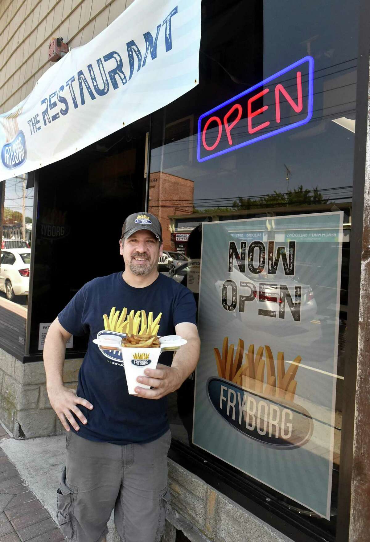 Milford, Connecticut - Friday, August 24, 2018: Jonathan Gibbons, owner of Fryborg in Milford, an eclectic eatery featuring hand-cut french fries as the main attraction with variation of flavorings and dipping sauces on a menu that also includes sandwiches, in front of his restaurant on Bridgeport Ave.