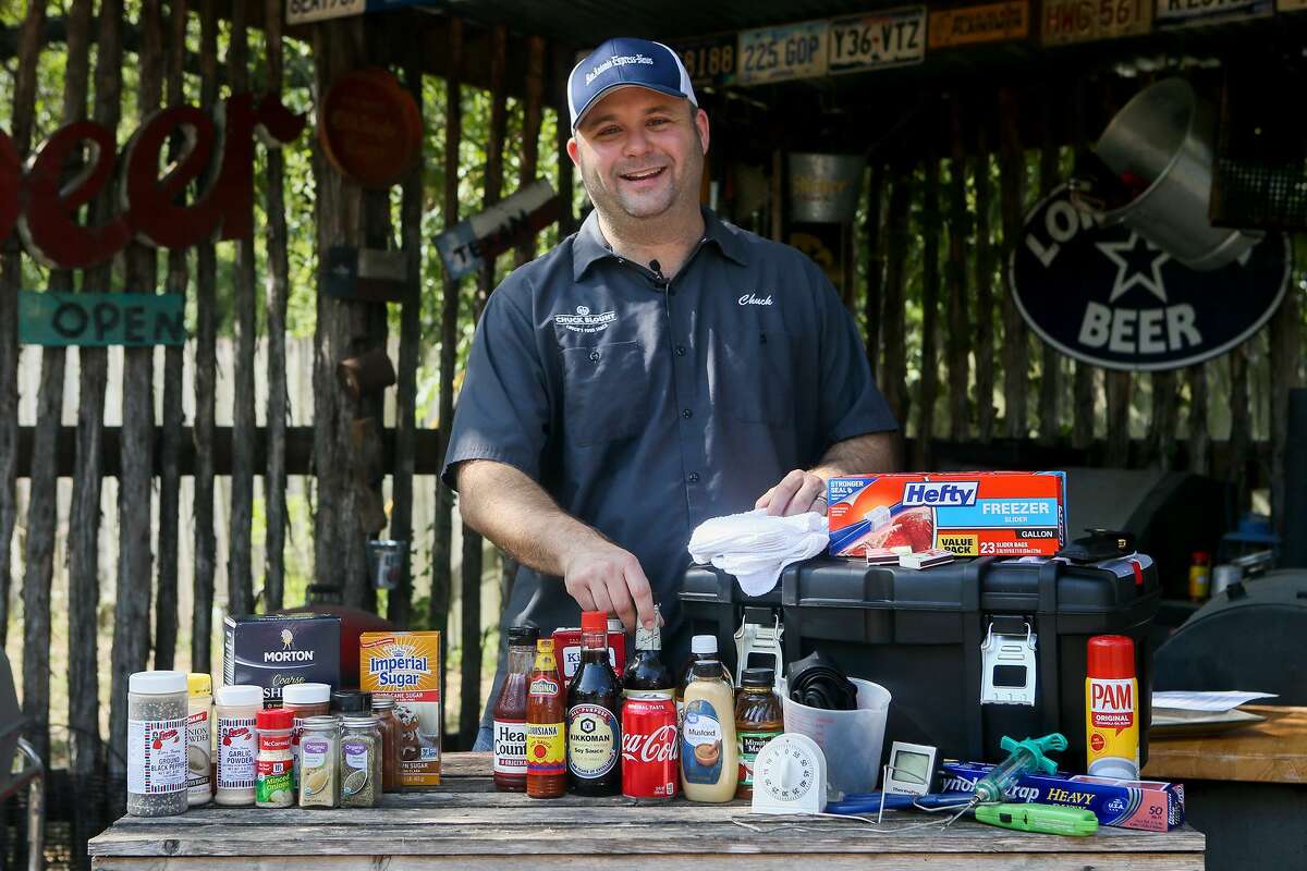 Chuck Blount stands behind an assortment of traditional spices (from left), wet ingredients and gadgets that he suggests to put into your BBQ toolbox at Chuck's Food Shack .