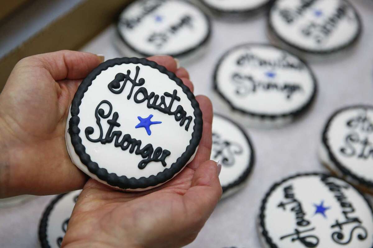 Three Brothers Bakery owner Janice Jucker holds a "Houston Stronger" cookies the bakery has created at the anniversary of Hurricane Harvey. The store on South Braeswood has flooded multiple times over the last decade and last year was inundated by four and a half feet of water during Hurricane Harvey.