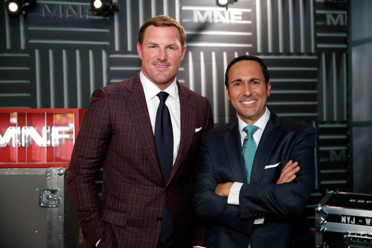 Former NFL player and no analyst Jason Witten, left, and play-by-play commentator Joe Tessitore pose for a photograph before their ESPN telecast of a preseason NFL football game between the Washington Redskins and the New York Jets, Thursday, Aug. 16, 2018, in Landover, Md. (AP Photo/Alex Brandon)