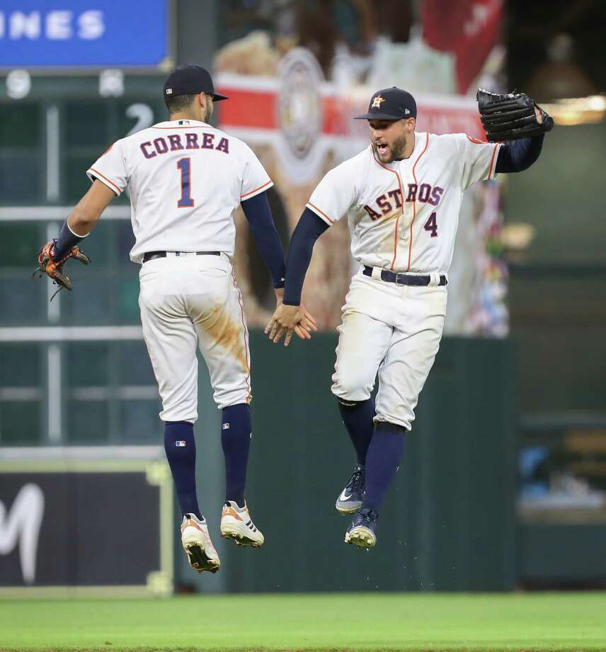 Houston Astros' shortstop Carlos Correa (1) and Houston Astros center fielder George Springer (4) celebrate after defeating the Oakland Athletics 11-4 during an MLB game at Minute Maid Park Monday, August 27, 2018, in Houston , Photo: Steve Gonzales, Staff Photographer / © 2018 Houston Chronicle