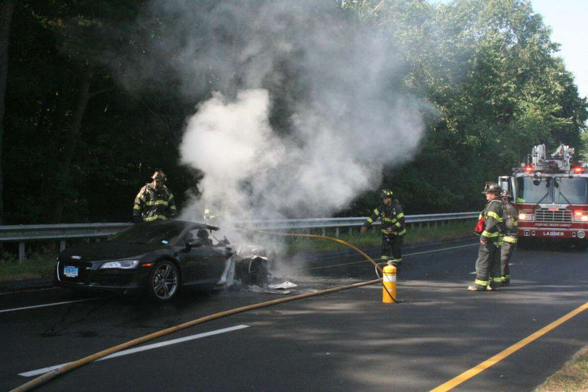 Fire officials are investigating the cause of an early morning car fire on the Merritt Parkway that destroyed an Audi R8 belonging to a Connecticut Powerball winner.