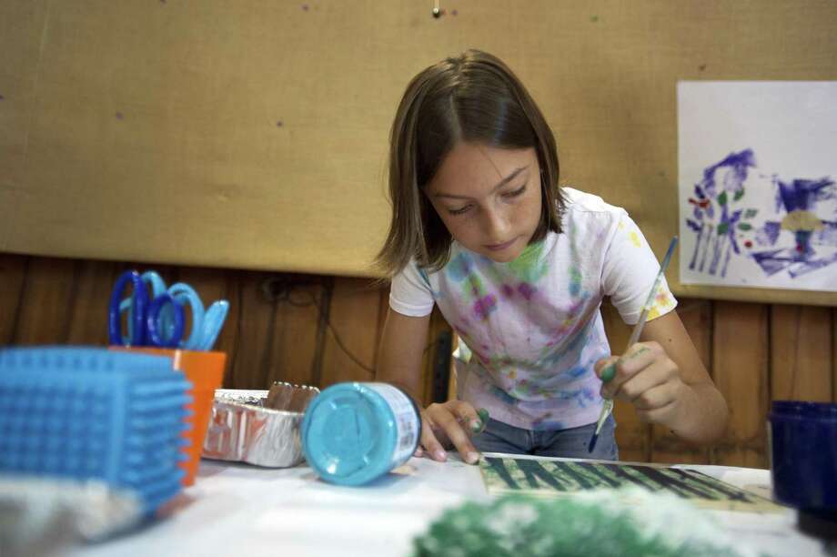 11-year-old finnia cheftel of weston works on a painting for