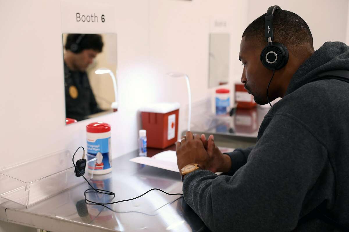 Christian Martin, executive director of Lower Polk Community Benefit District, listens to a personal testimony as he attends a tour during the Safer Inside Demonstration at GLIDE in San Francisco, Calif., on Tuesday, August 28, 2018. The demonstration was a full-scale and operational demonstration model of an overdose prevention site open to the community for outreach and education. The tours run through August 31 in the Tenderloin neighborhood.