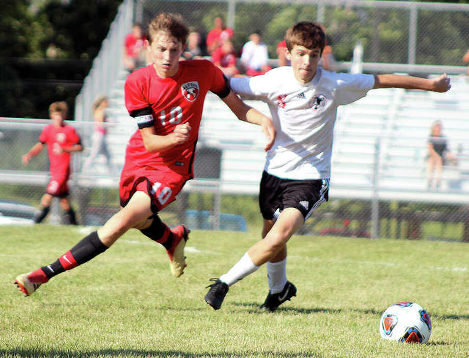 Alton’s Jake Lombardi (10) and Granite City’s Hunter Harnetieux race for the ball during prep soccer action Tuesday at Alton High School. Alton rallied from a 2-0 halftime deficit to win 3-2. Photo: Pete Hayes | The Telegraph
