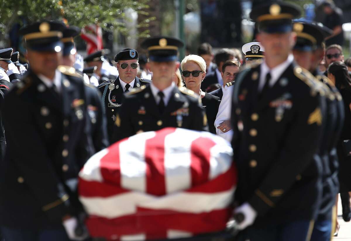 PHOENIX, AZ - AUGUST 29: Cindy McCain, wife of U.S. Sen. John McCain (R-AZ) walks behind his casket as it is carried into the Arizona State Capitol on August 29, 2018 in Phoenix, Arizona. U.S. Sen. John McCain will lie in State at the Arizona State Capitol before being transported to Washington D.C. where he will be buried at Arlington National Cemetery. Sen. McCain, a decorated war hero, died August 25 at the age of 81 after a long battle with Glioblastoma, a form of brain cancer. (Photo by Justin Sullivan/Getty Images)