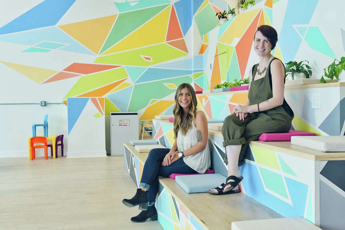 Sarah Johnston, left, director of operations for CoLab and Stacks Espresso Bar and Katie McKenna, community manager for CoLab, pose for a photo inside the CoLab space on Wednesday, July 25, 2018, in Albany, N.Y. (Paul Buckowski/Times Union)