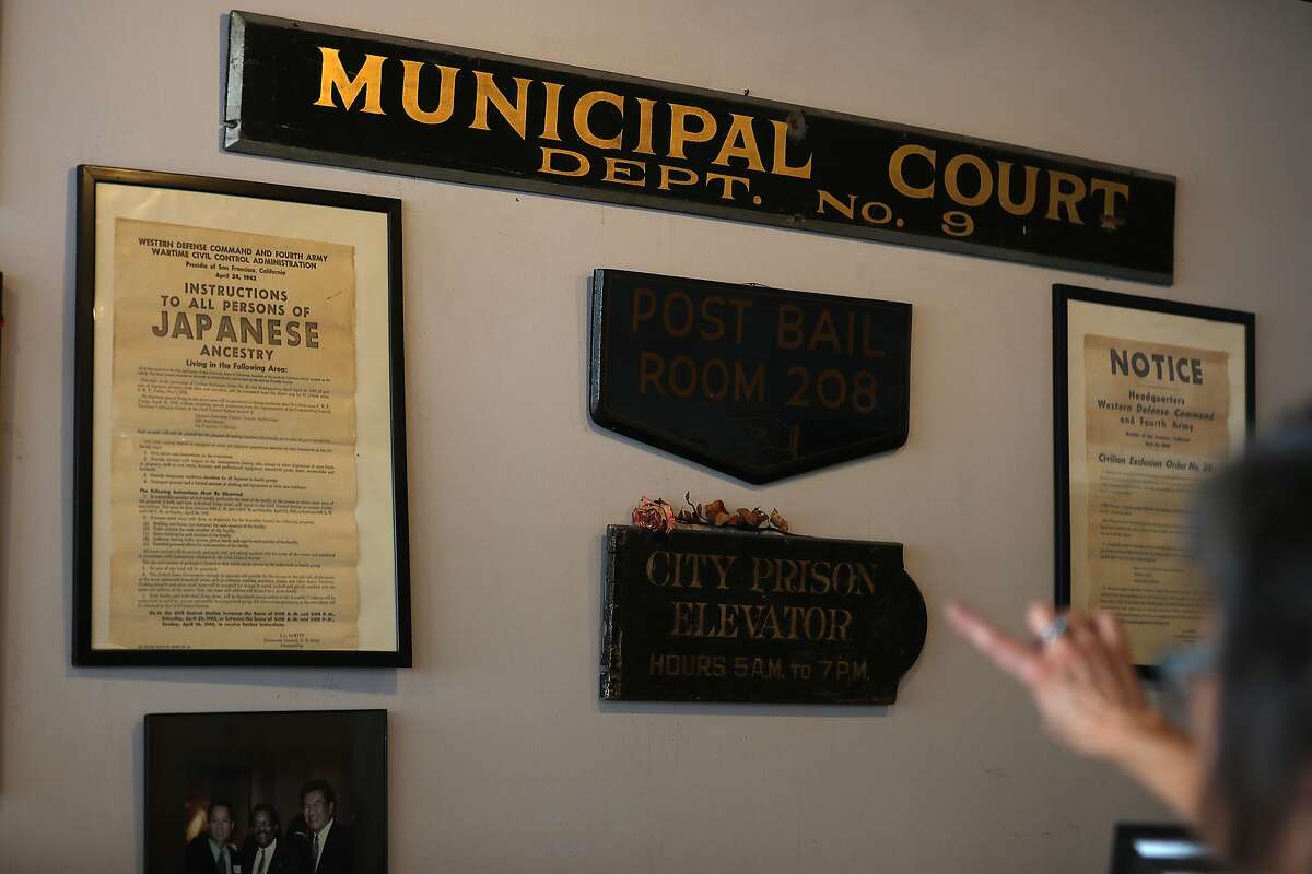 Owner Geri Campana of Al Graf Bail Bonds who has run the company for 35 years shows memorabilia on her wall including when her parents were incarcerated during world war one and old signs from the hall of justice when it was renovated seen on Wednesday, Aug. 29, 2018 in San Francisco, Calif.