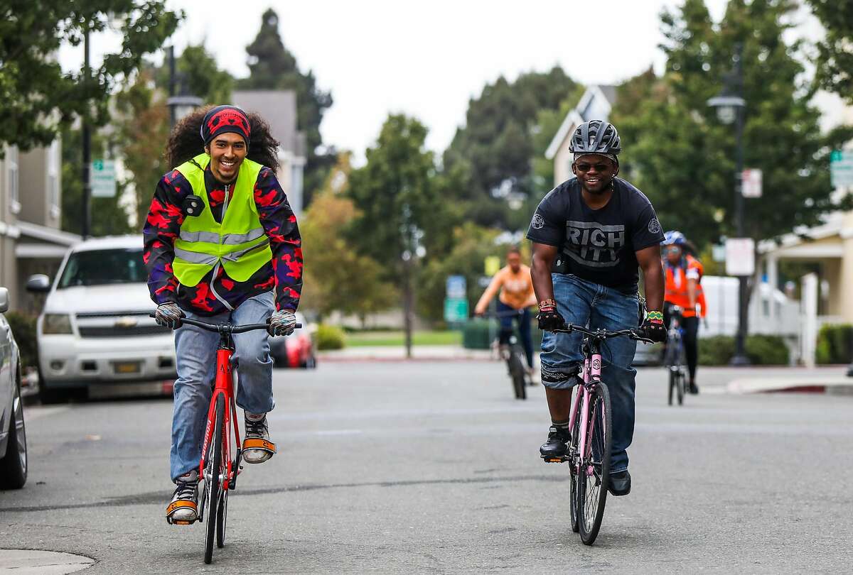 Executive director of Rich City Rides Najari Smith (right) participates in a community bike ride in Richmond, California, on Sunday, Aug. 27, 2018. Rich City Rides is a bike shop and community cycling organization.