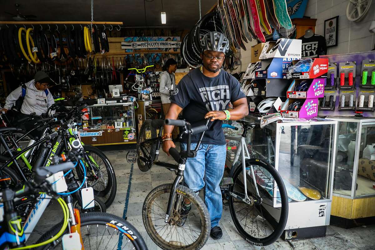 Executive director of Rich City Rides Najari Smith gets a bicycle out for a participant ahead of a group ride in Richmond, California, on Sunday, Aug. 27, 2018.