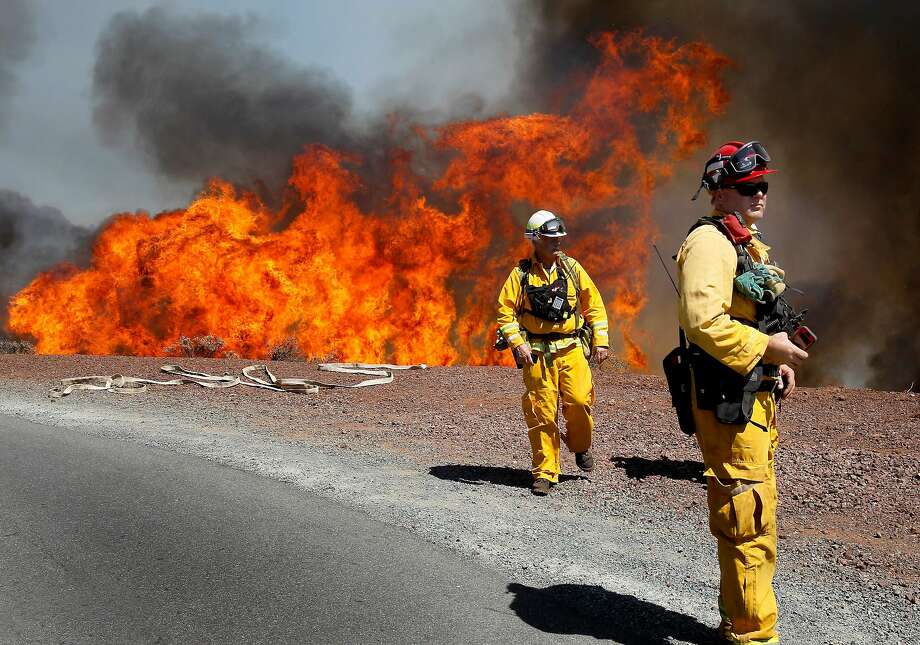 Fire fighters backed away from the flames as they approached Summit Road Monday September 9, 2013. The Morgan fire burned over the summit of Mount Diablo State Park as fire fighters and air tankers battled to keep it contained to the park. Photo: Brant Ward / The Chronicle 2013