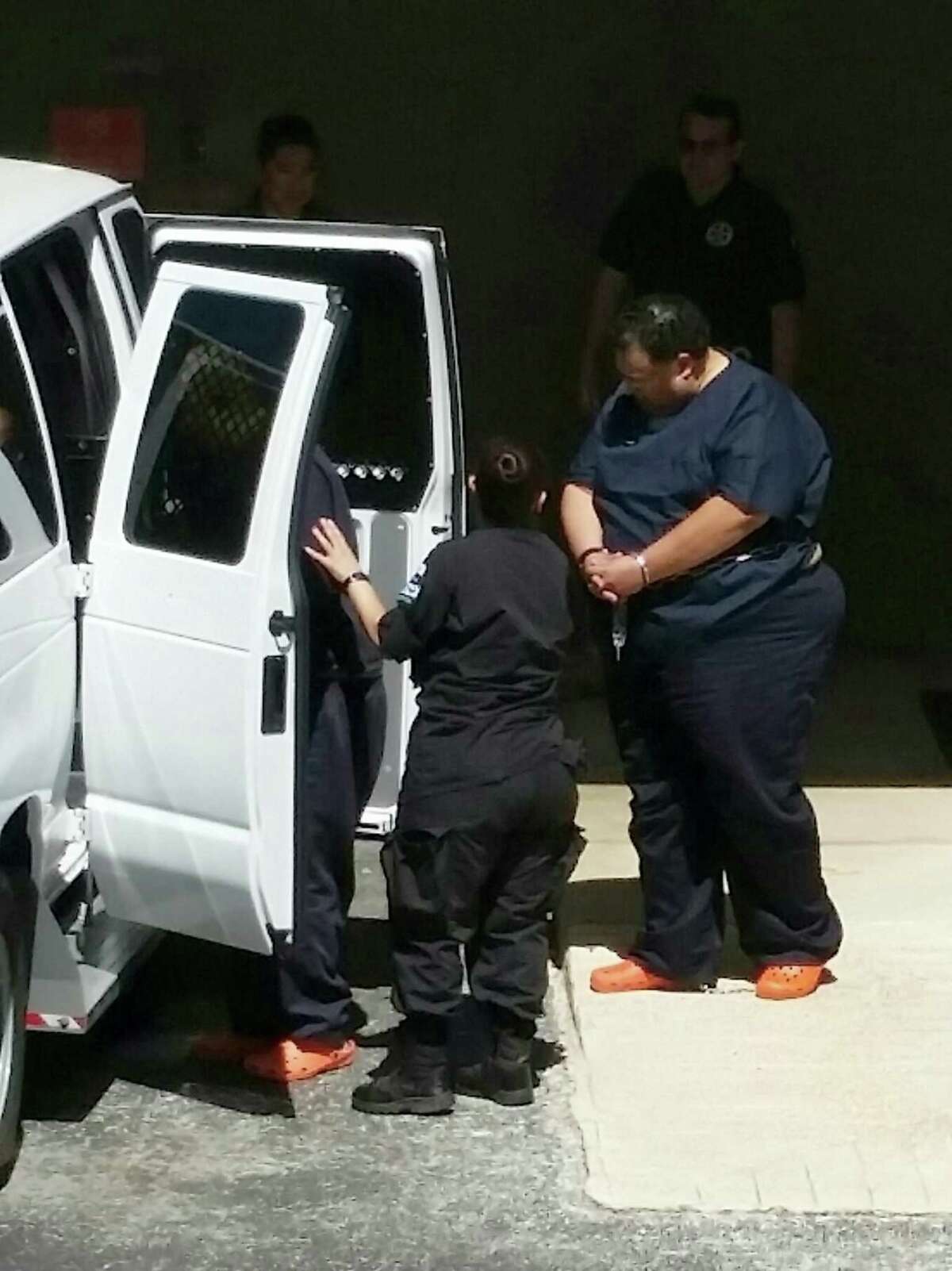 Mark Anthony Rodriguez, 52, loaded into a jail van outside the federal courthouse.