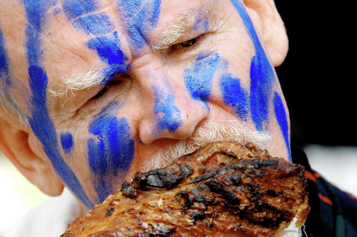 Doug Ewen of Conn., wearing Scottish battle paint, chews on a smoked turkey leg during the 2005 Scottish Games at the fairgrounds in Altamont, New York, Saturday September 3, 2005. The Capital District Scottish Games return on Saturday, September 3 2022. (Michael P. Farrell/Times Union)