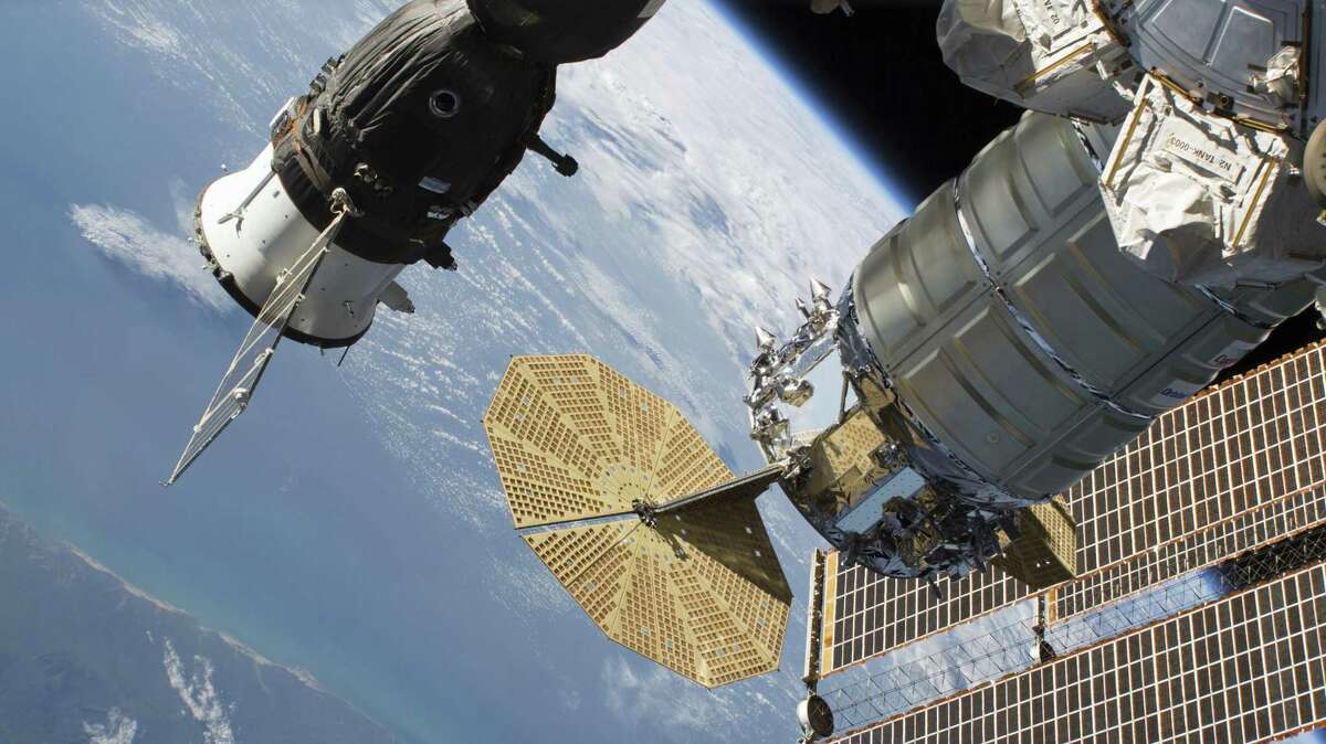 In this June 24, 2018 photo released by NASA, the Russian Soyuz MS-09 crew craft, left, and the Northrop Grumman (formerly Orbital ATK) Cygnus space freighter are attached to the International Space Station. NASA and Russian space officials stressed Thursday, Aug. 30, 2018, that the six astronauts are in no danger after a small air leak developed in one, at left, of the two Soyuz capsules docked at the space station.