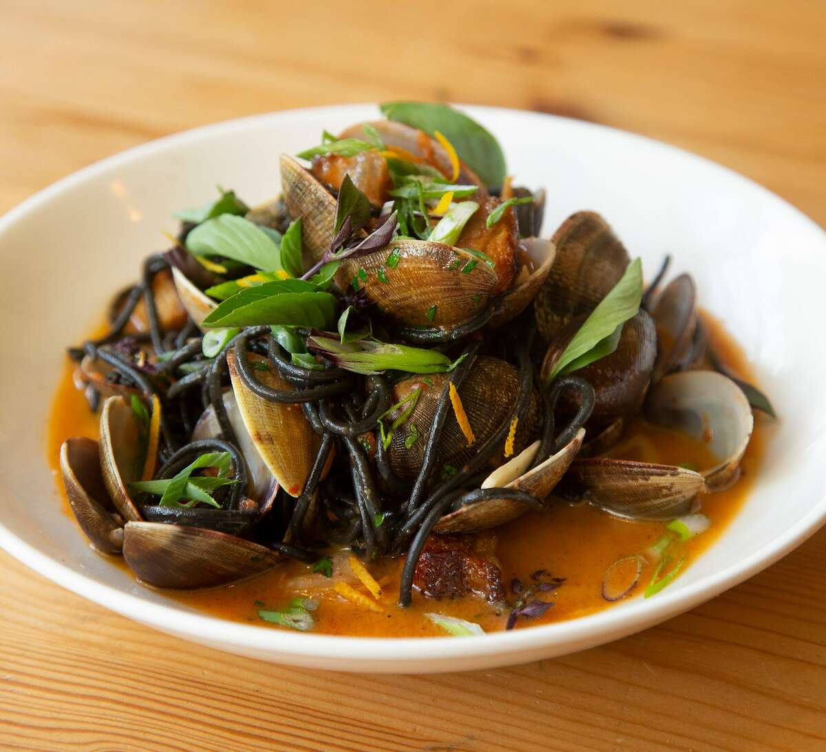 Squid ink spaghetti with manilla clams, pork belly and tanuki cider fermented chili miso broth is one of the menu items offered at Home restaurant on Wednesday, 8/8, 2018 in Soquel, California. Home is one of several Monterey Bay area restaurants recommended by Soerke Peters who is president of the Monterey Bay chapter of American Culinary Federation.