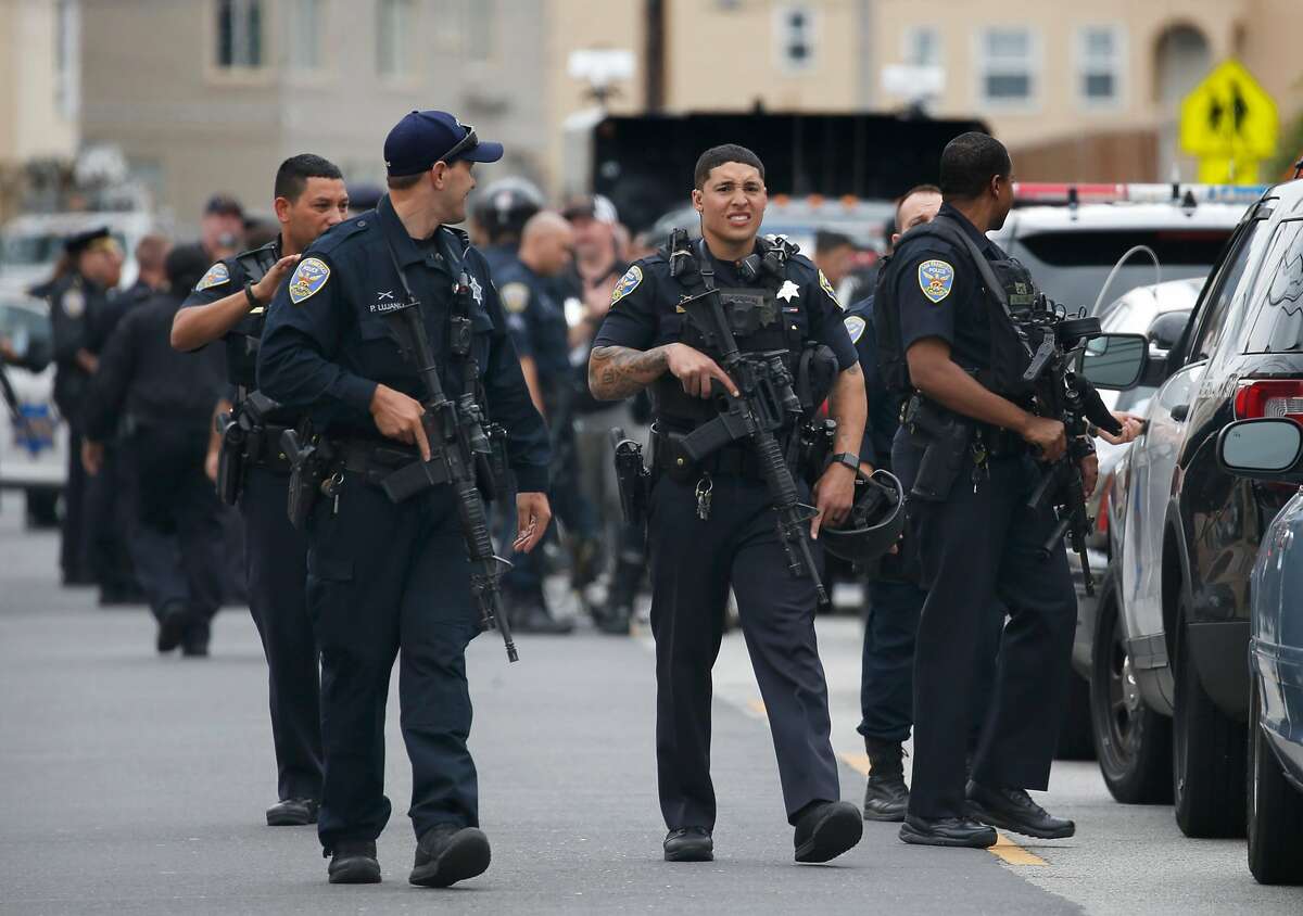 Police officers carry automatic weapons at Balboa High School after responding to reports of an active shooter on campus in San Francisco, Calif. on Thursday, Aug. 30, 2018.