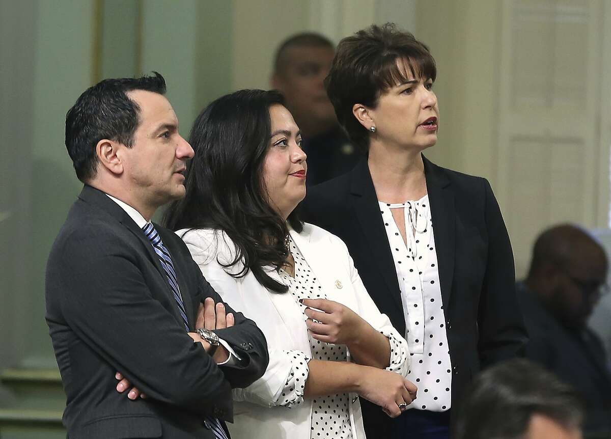 State Sen. Connie Leyva, D-Chino, right, along with Los Angeles-area Assemblywoman Wendy Carrillo, and Assembly Speaker Anthony Rendon, D-Lakewood, watches as the votes are posted for her measure to require all public universities to offer medication abortions at campus health centers, Wednesday, Aug. 29, 2018, in Sacramento, Calif. The Assembly approved the bill and sent it to the Senate. (AP Photo/Rich Pedroncelli)