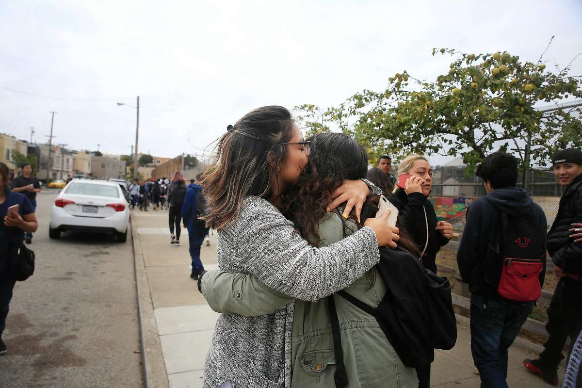 Cindy Castillo (l to r) kisses her sister Balboa High School sophomore Patricia Martinez. 15, as they are reunited after a gun incident at Balboa High School on Thursday, August 30, 2018 in San Francisco, Calif. Multiple schools in the area near San Francisco's Balboa Park went into lockdown around noon Thursday after an "incident" that left one student injured, three persons detained and a firearm recovered, authorities said.