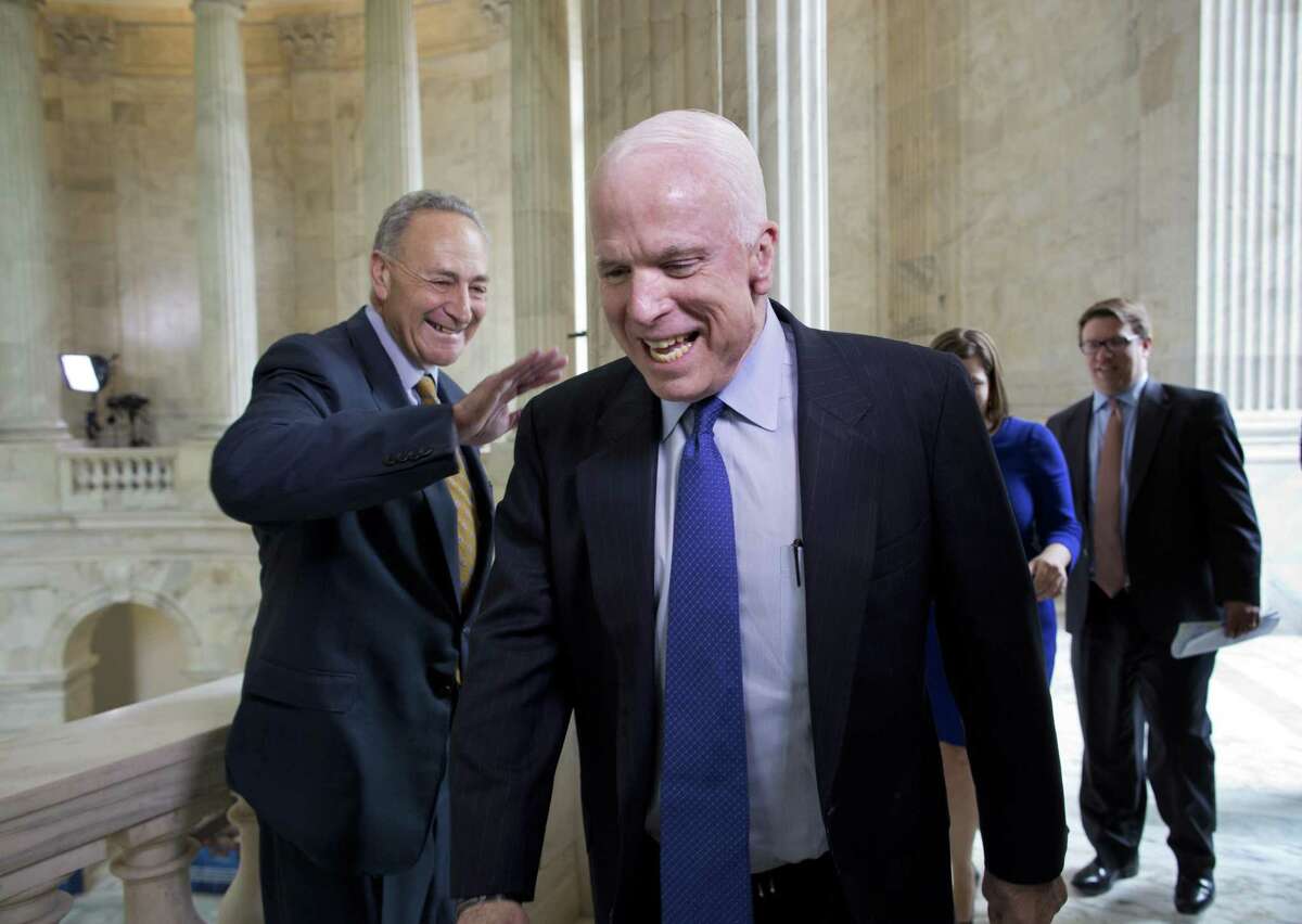 Sen. John McCain, R-Ariz., and Sen. Chuck Schumer, D-N.Y. (left), cross paths in the Russell Senate Office Building in 2013. Readers praise McCain, who died Saturday.
