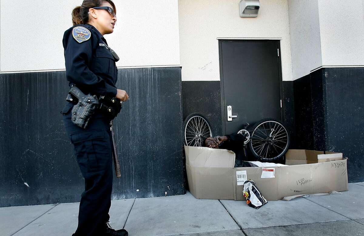 badge_homeless_109.JPG Officer Espinoza stops to check on " the bush man" who is sleeping near the SPCA. The bush man has a skit he performs at Fisherman's Wharf to make money. Espinoza is trying to get him city services. Priscilla Espinoza is one of four SFPD officers at the Mission station who patrol the streets of San Francisco trying to improve the lives of the homeless. She really cares about the plight of the homeless and works with medical and outreach teams to bring services to the downtrodden. {Brant Ward/San Francisco Chronicle}6/6/07