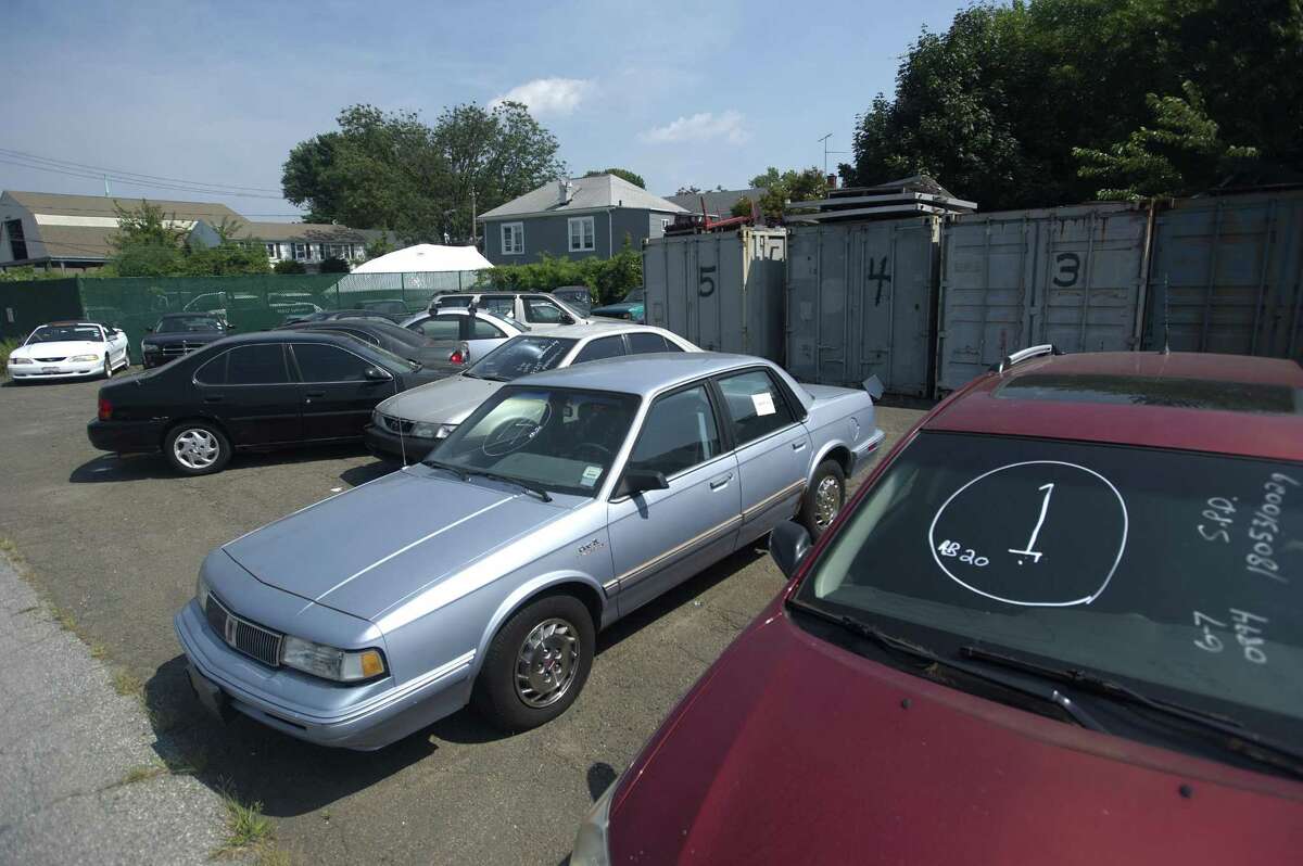 Cars in various conditions sit in the city of Stamford's fleet management lot on Magee Ave. after being abandoned and towed in Stamford, Conn. on Tuesday, Aug. 28, 2018. About every two months the cars not claimed get auctioned off to the highest bidder.