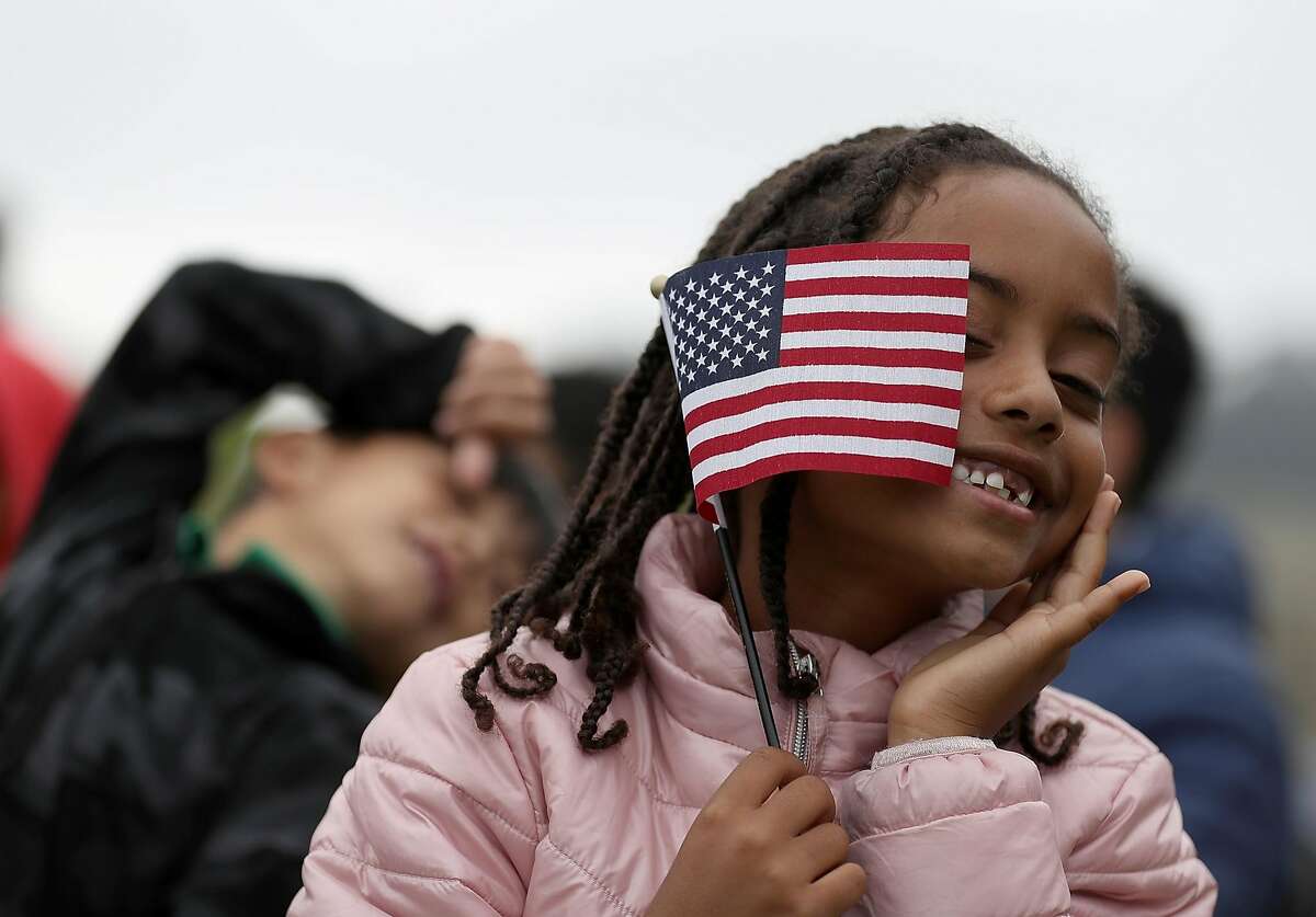 *** BESTPIX *** SAN FRANCISCO, CA - AUGUST 17: Sophia Biniam, 7, holds an American flag during a naturalization ceremony for kids between the ages of 6-12 at Crissy Field near the Golden Gate Bridge on August 17, 2018 in San Francisco, California. Thirty-two children from seven countries were sworn in as U.S. citizens during a special naturalization ceremony. (Photo by Justin Sullivan/Getty Images)