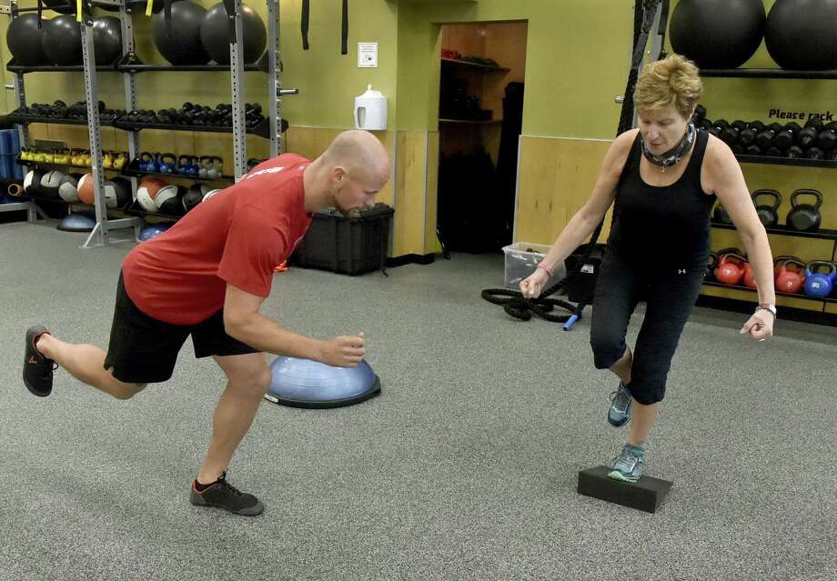 kevin gregory, a trainer at edge fitness, of hamden, left