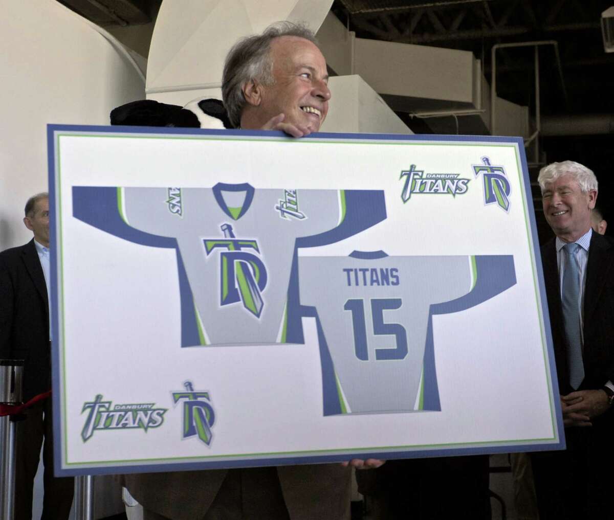 Bruce Bennett, of Danbury, holds up an illustration of a home jersey for the Danbury Titans during a press conference to announce the new Federal Hockey League team in Danbury, Conn, on Friday, July 24, 2015. 