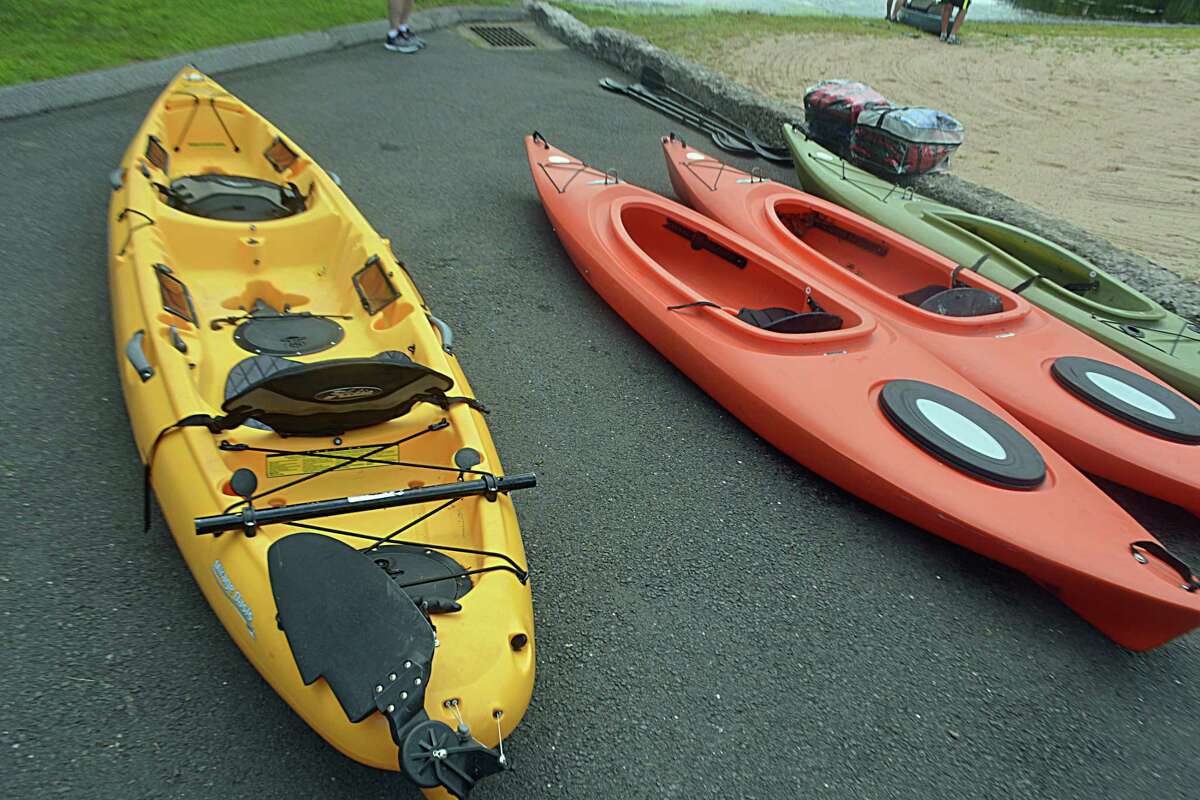 An adaptive kayak sits next to traditional kayaks at Crystal Lake in Middletown.