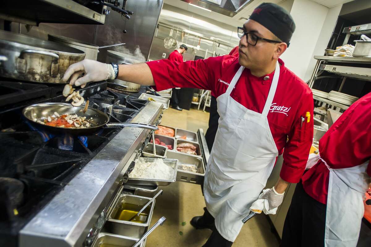 Gratzi Chef Ismael Herrera prepares a pasta dish on Friday at the restaurant, which won the 2018 Daily News Readers' Choice gold awards for best happy hour, most romantic dinner and best waitress. (Katy Kildee/kkildee@mdn.net)