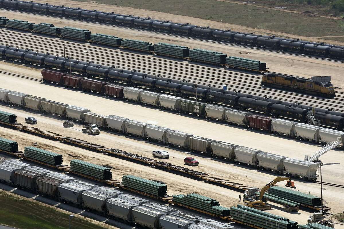Rail cars load and unload at the Gardendale Railroad Inc. switching yard in LaSalle County near Cotulla, Texas, in 2012. More oil is starting to be sent from West Texas to the Gulf Coast by truck and rail as pipelines out of the Permian Basin are full of crude.
