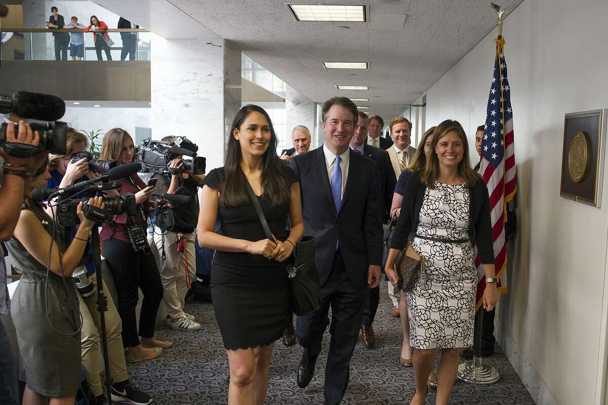 Supreme Court nominee Brett Kavanaugh, center, walks to the office of Sen. Heidi Heitkamp, D-N.D., for a meeting with her on Capitol Hill in Washington, Wednesday, Aug. 15, 2018. (AP Photo/Cliff Owen)