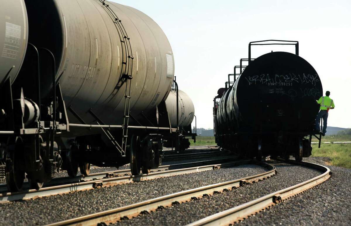 Hondo Railway worker rides on a tanker car as rail cars are moved to be unloaded. The company has seen growth with the increased business from the Eagle Ford Shale oil production in South Texas. Friday, Sept. 21, 2012.