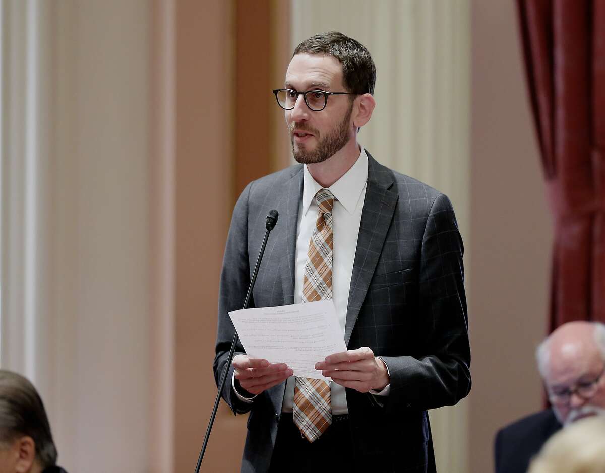 State Sen. Scott Wiener, D-San Francisco, addresses the state Senate, Thursday, Aug. 30, 2018, in Sacramento, Calif. The Assembly approved Wiener's net neutrality bill seeking to revive regulations repealed last year by the Federal Communications Commission that prevented internet companies from exercising more control over what people watch and see on the internet. (AP Photo/Rich Pedroncelli)