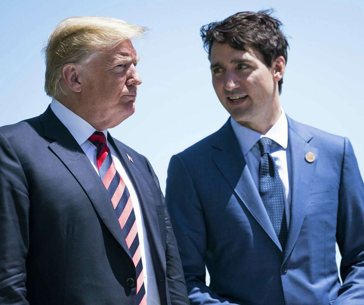 Canadian Prime Minister Justin Trudeau talks with President Donald Trump during a welcome ceremony at the G-7 summit meeting at the Fairmont Le Manoir Richelieu in La Malbaie, Quebec, in June. Trump on Friday notified Congress that he plans to sign a new trade deal with both Canada and Mexico.