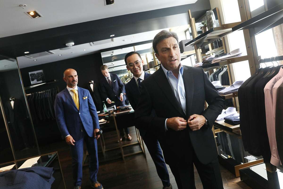 Antonello Pagliuca (l to r), master tailor, and Thom Nguyen, specialist for Brioni, assist Gary Schwartz as he tries on a tuxedo jacket after it had been altered at Wilkes Bashford on Friday, August 31, 2018 in San Francisco, Calif.
