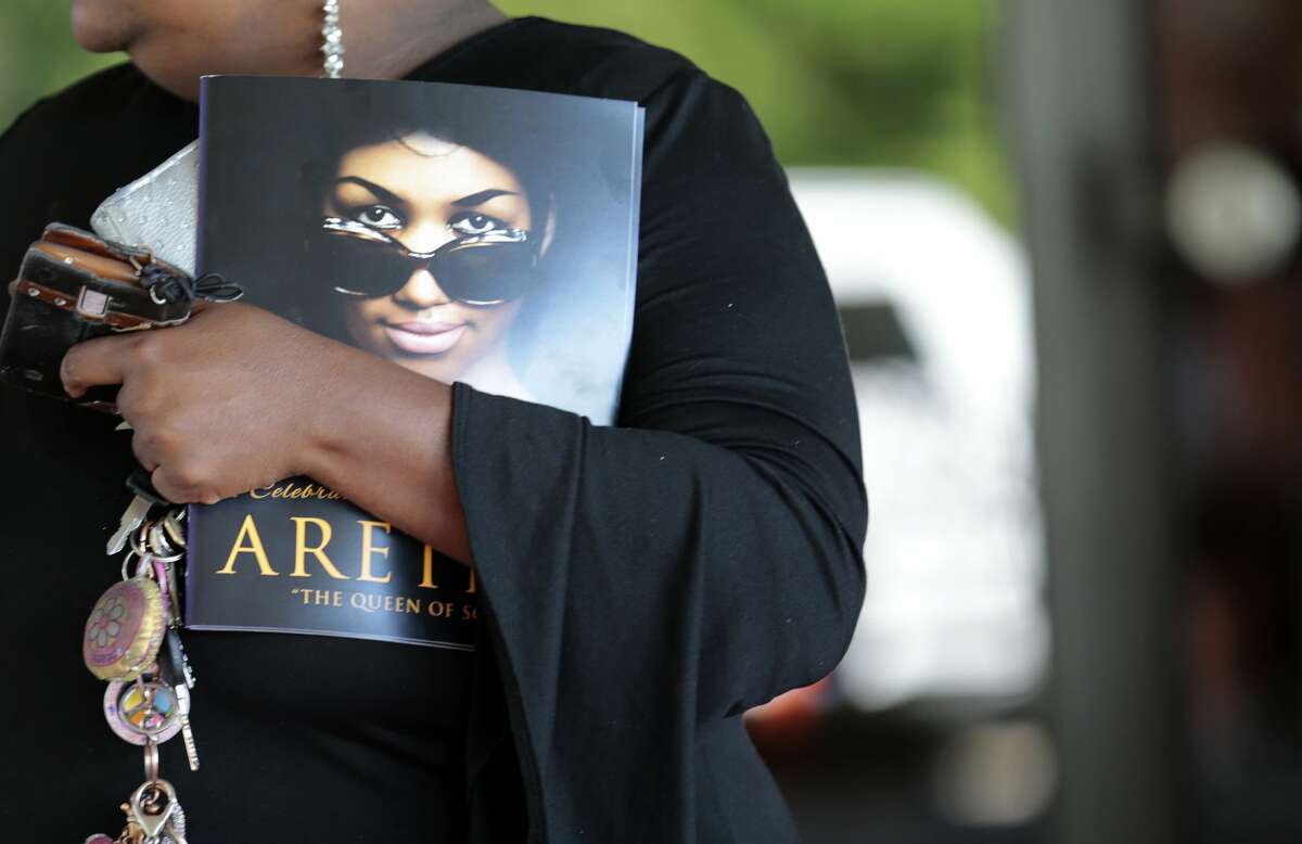 A woman holds a program from Aretha Franklin's funeral at the Greater Grace Temple in on August 31, 2018 in Detroit, Michigan. (Photo by JEFF KOWALSKY / AFP) (Photo credit should read JEFF KOWALSKY/AFP/Getty Images)
