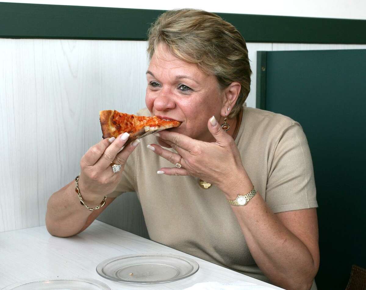 Donna Werfelman of Trumbull tries Pepe's Pizza.