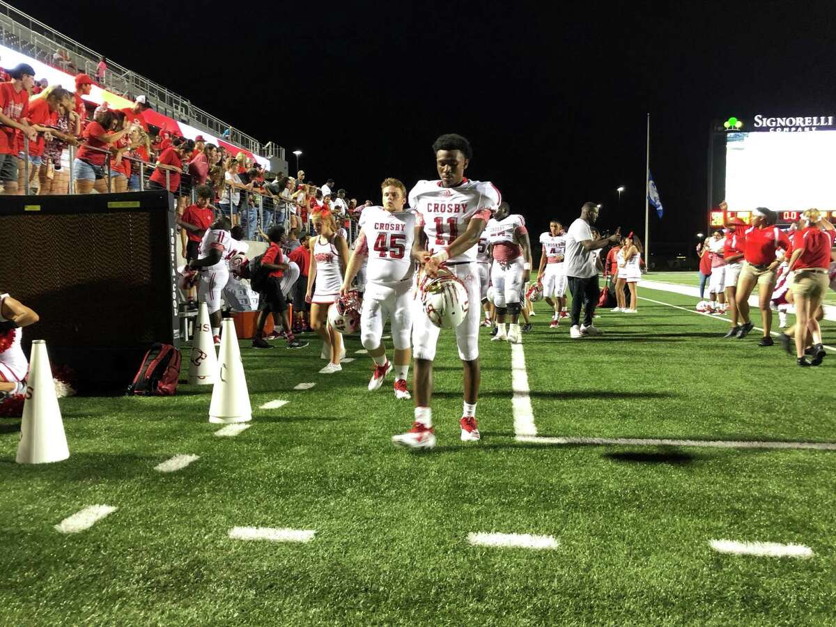 Crosby's Jaylen Herman (11) and Matthew Miley (45) walk to the locker room following the Cougars victory over New Caney on August 31 at Texan Drive Stadium