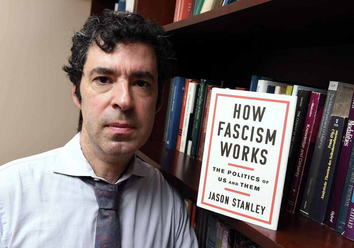 Yale University philosophy professor Jason Stanley is photographed with his new book, “How Fascism Works: The Politics of Us and Them,” at his office in Connecticut Hall on Yale University’s Old Campus.