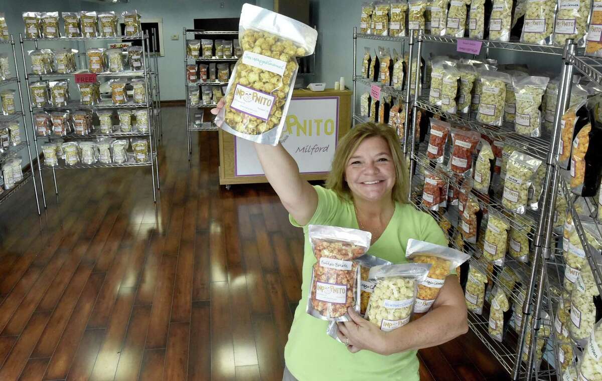 Stephanie Dudding, owner of Inpopnito, in the new shop that sells gourmet flavored popcorn at 3 River St. in Milford.