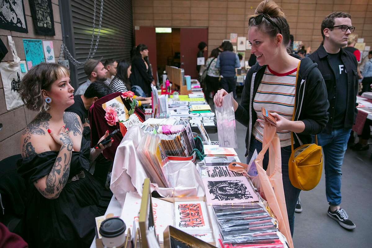 Laura Braun purchases some original art work from Gracie CT (left) during the 17th Annual San Francisco Zine Fest at the San Francisco County Fair Building in Golden Gate Park, Sunday 02 September 2018 in San Francisco, CA.