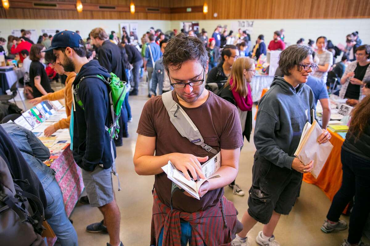 Gavin Morgan could not wait to start reading one of his recently purchased Zines, as he stood in the center of the aisle at the 17th Annual San Francisco Zine Fest at the San Francisco County Fair Building in Golden Gate Park Sunday 02 September 2018 in San Francisco, Calif.