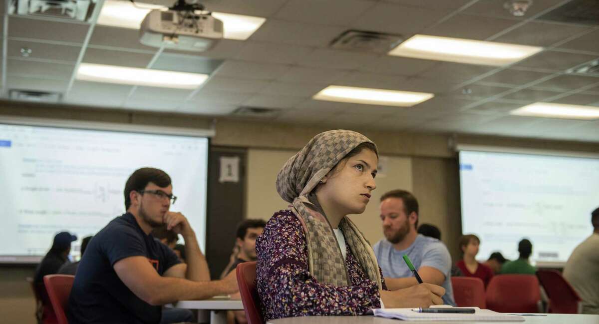 Saeideh Ahmadi listens to Adolfo Matamoros, director of the UTSA civil engineering doctoral program, lecture about ?’reinforced concrete design?“ on how to build longevity into building structures on Friday, August 31st, 2018. The doctoral program opened this semester to respond to demand for more civil engineering which, experts say, was learned after Hurricane Harvey. The civil engineering PhD program has twenty students, more than triple their expectations. UTSA Population growth in Texas plus Hurricane Harvey have shown a need for more civil engineers, especially along the coast because coastal engineering is so specific and complex, engineering experts say. Previously, students wanting this specific PhD would've gone to Austin or Houston.