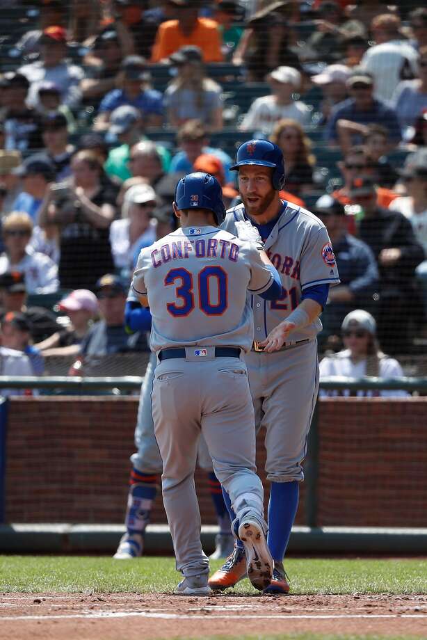 conforto #30 of the new york mets is congratulated by teammate
