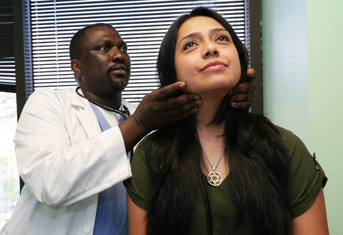 MBBS, MPAS, PA-C Wale Oshin performs check-up examine on patient Sandra Calderon at the East Harris County location of the United Health Partner (UHP) clinic on Friday, Aug. 31, 2018, in Houston. UHP has helped predominantly Blacks and Hispanics with Harvey relief. Calderon, 34, first learned about the clinic through the clinic's community outreach meeting and became a patient two weeks ago.